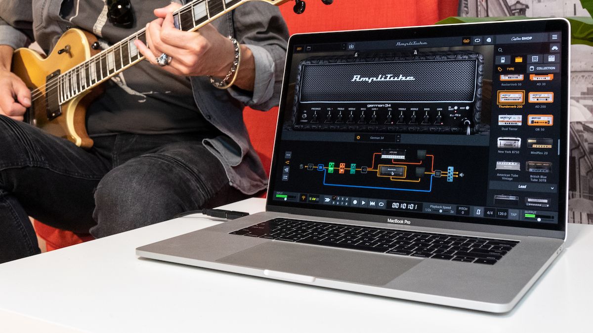 Indie musician uploading music tracks to TRAX on-chain platform using a laptop
